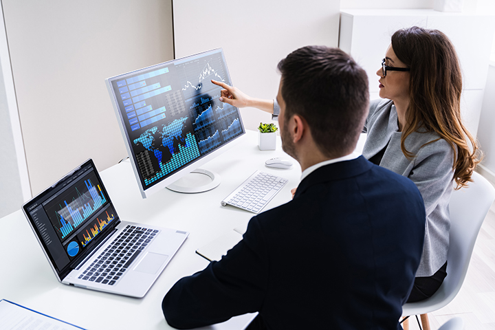 people analyzing data on computer screen