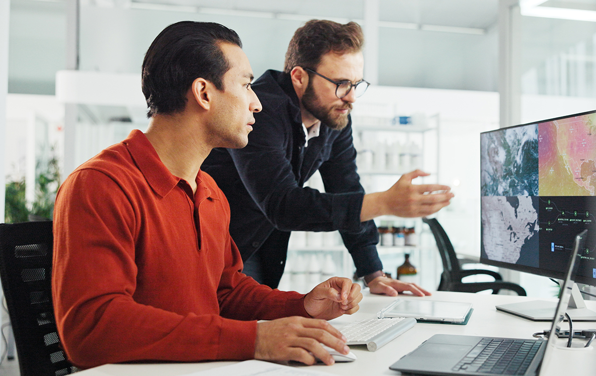 Two men analzing computer information