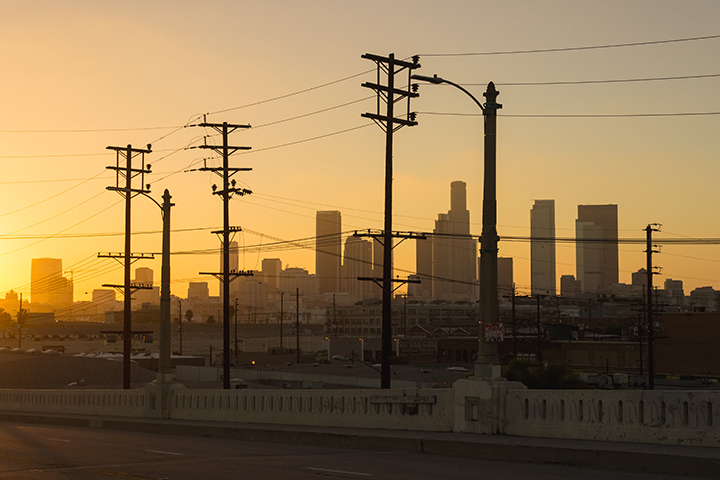Powerlines in city at sunset