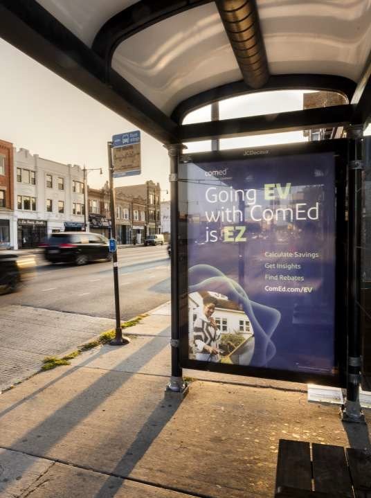 A bus stop with ComEd's Going EV is EZ campaign marketing on the side.