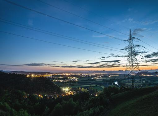 Image of power lines and city at night