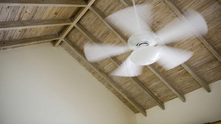 How efficient are whole-house fans compared to ceiling fans?