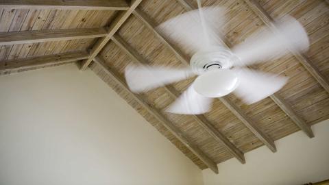 How efficient are whole-house fans compared to ceiling fans?