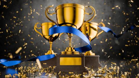 Three trophies on a festive background