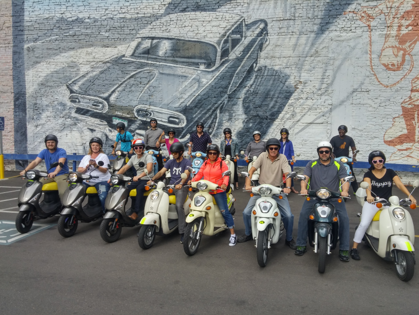 Image of Forum attendees enjoying a scooter tour