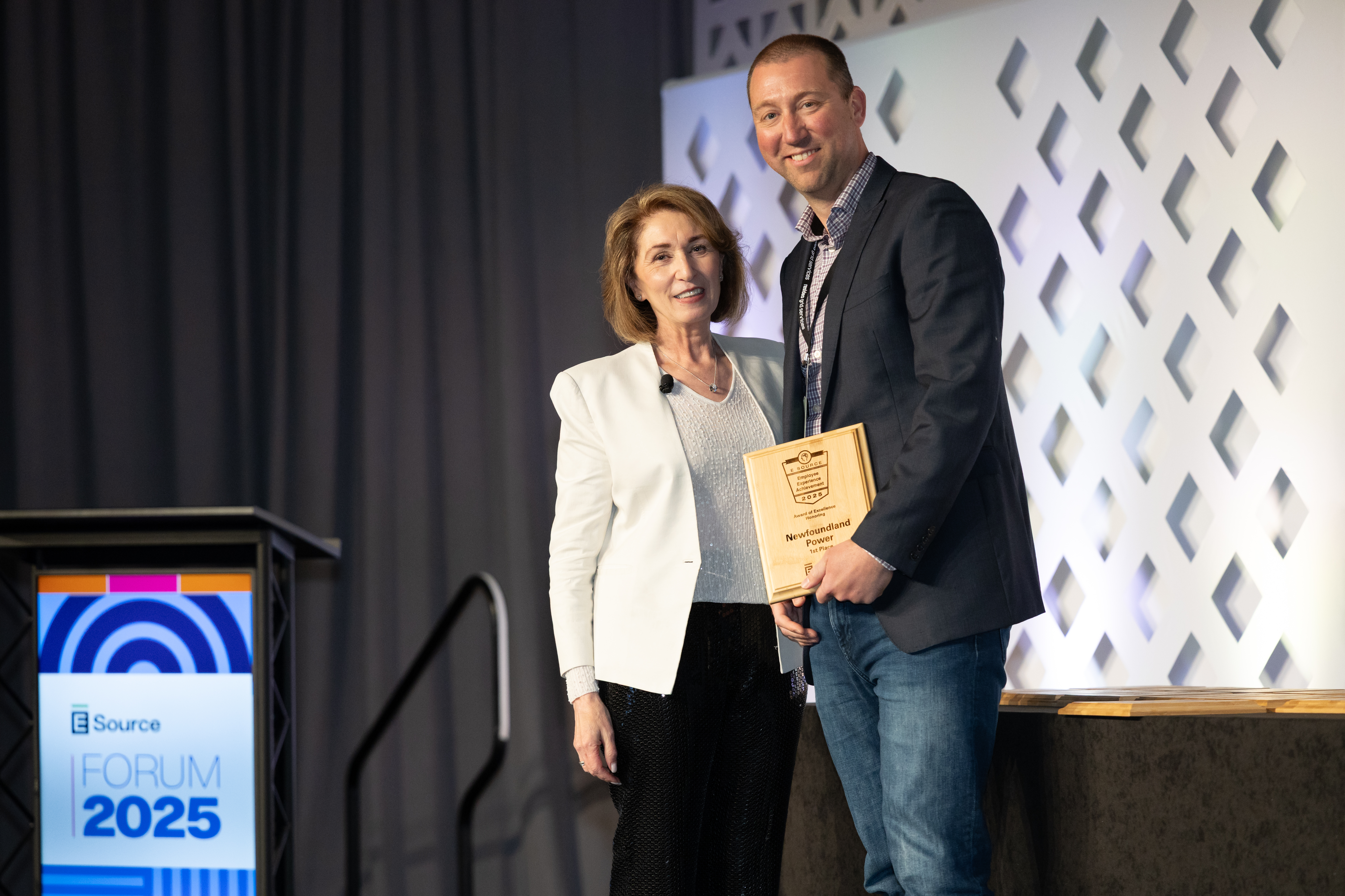 Attendee accepting the award for Achievement in Employee experience at the Forum.